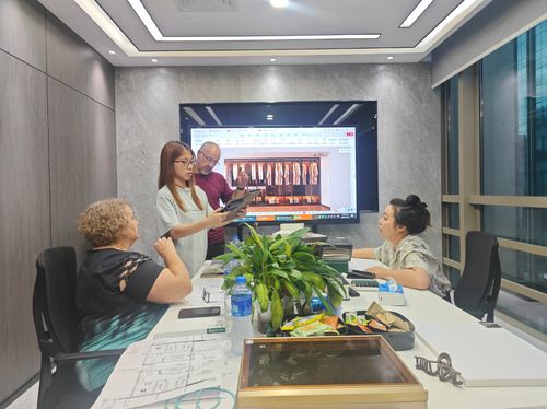Relvano sales team with client reviewing whole-house custom cabinetry